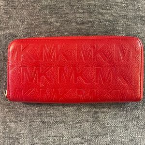 Red leather Michael Kors embossed wallet. Missing MK disk on zipper pull